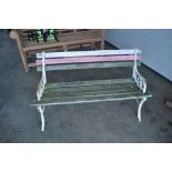 A wooden and metal child's garden bench