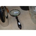 A magnifying glass (90)