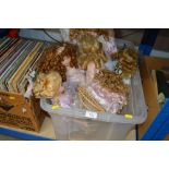 A box of various dress dolls