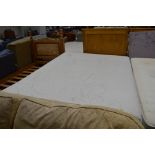 A double divan bed missing one caster