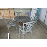 A metal garden table with four matching chairs