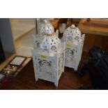 Three white painted metal candle lanterns