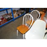 A pair of white painted spindle back chairs