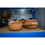 Three graduating Le Creuset saucepans