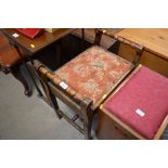 A mahogany piano stool with floral upholstery