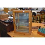 An oak and glazed single door cabinet AF