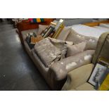 A brown and floral upholstered three seater settee