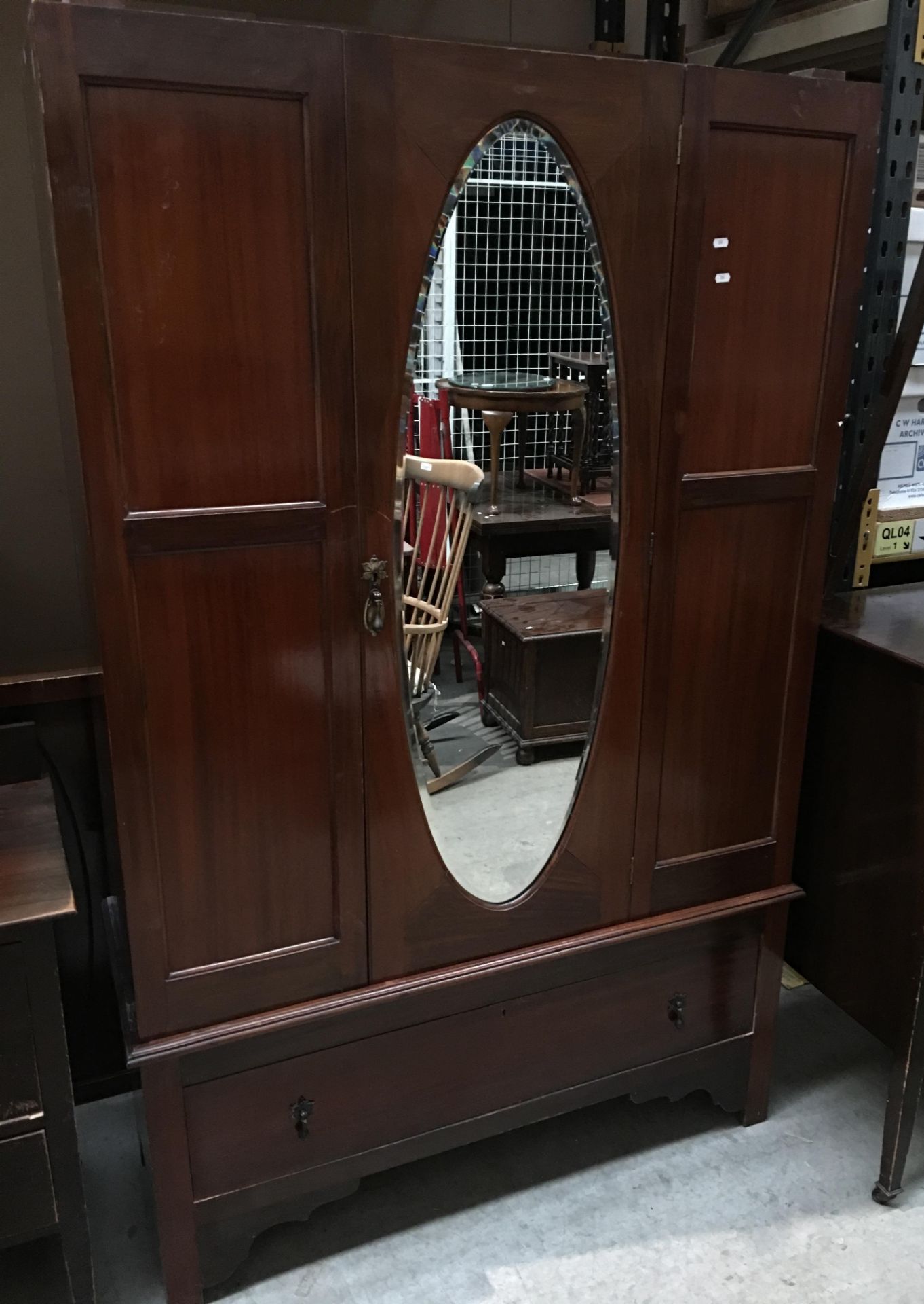 A mahogany four piece bedroom suite comprising wardrobe with centre mirror door and underdrawer,