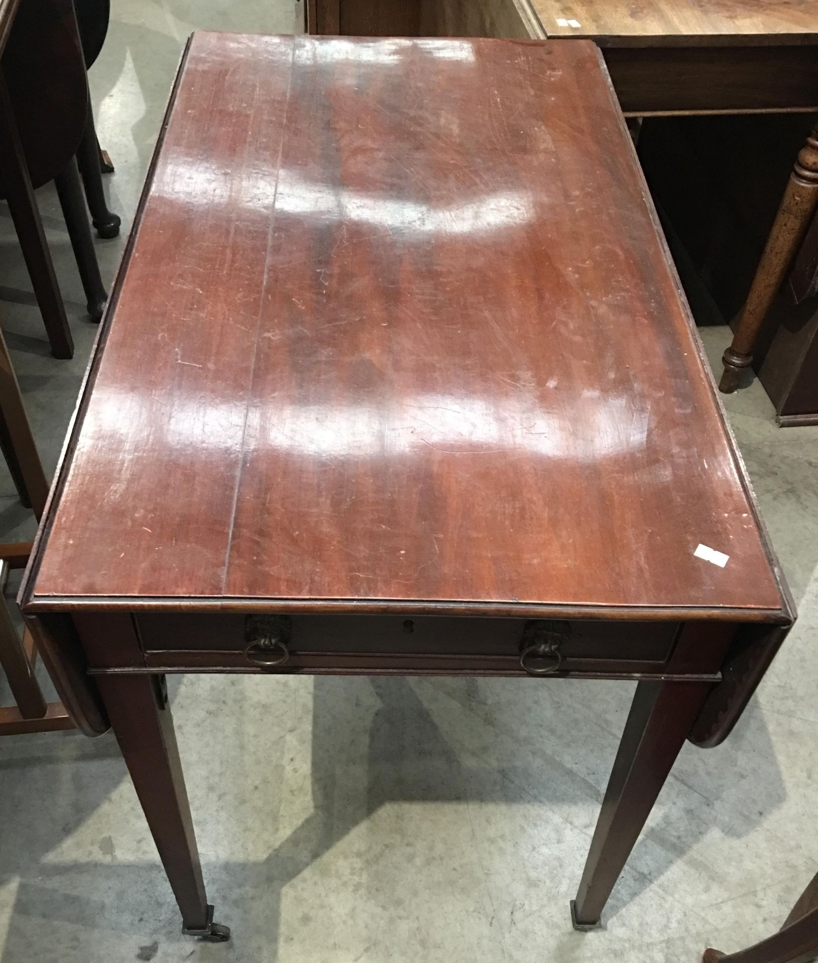 A mahogany drop leaf Pembroke table on tapered legs, with single drawer and dummy drawer,