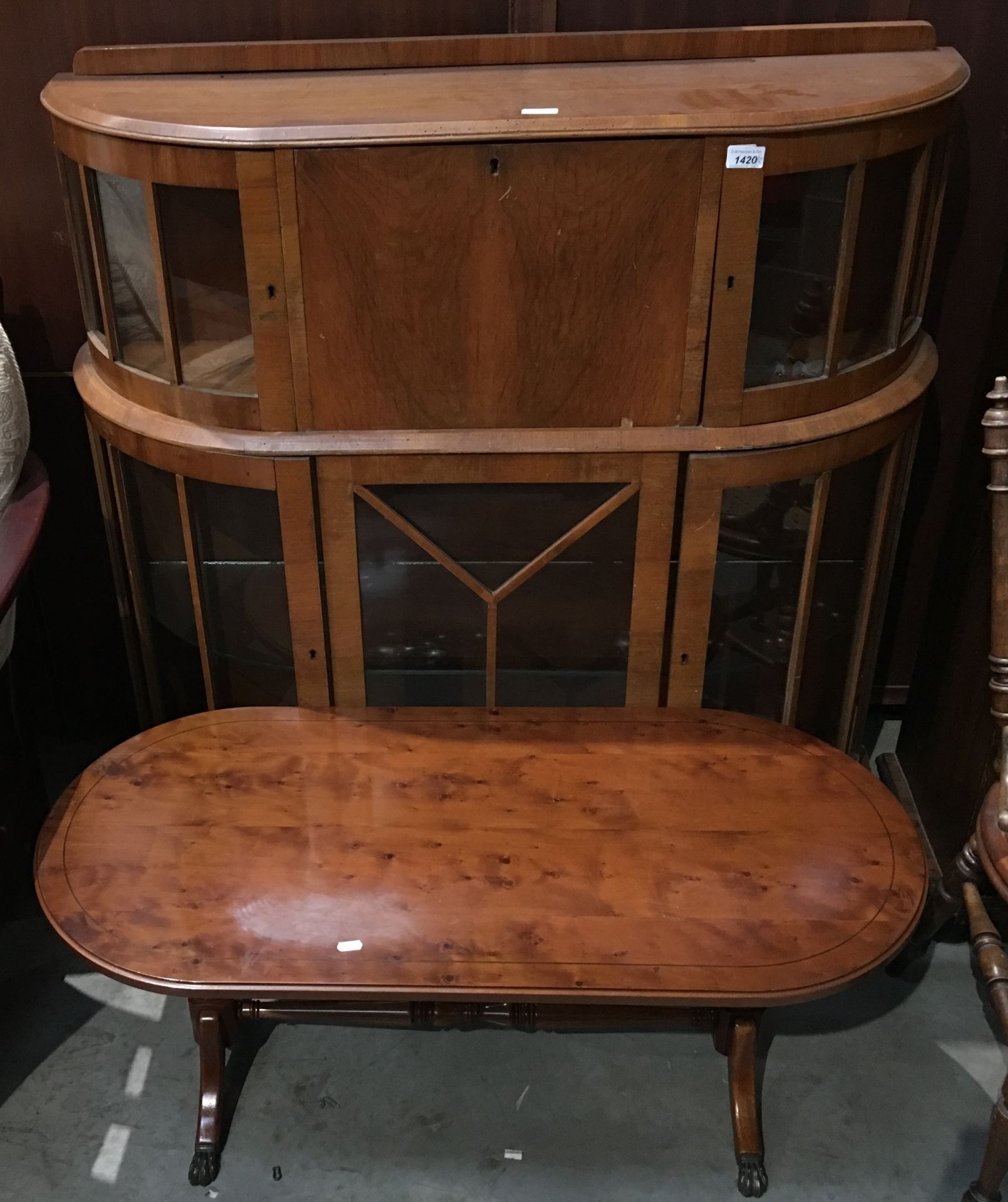 A walnut bow front display cabinet 110cm and a small walnut circular coffee table (2)