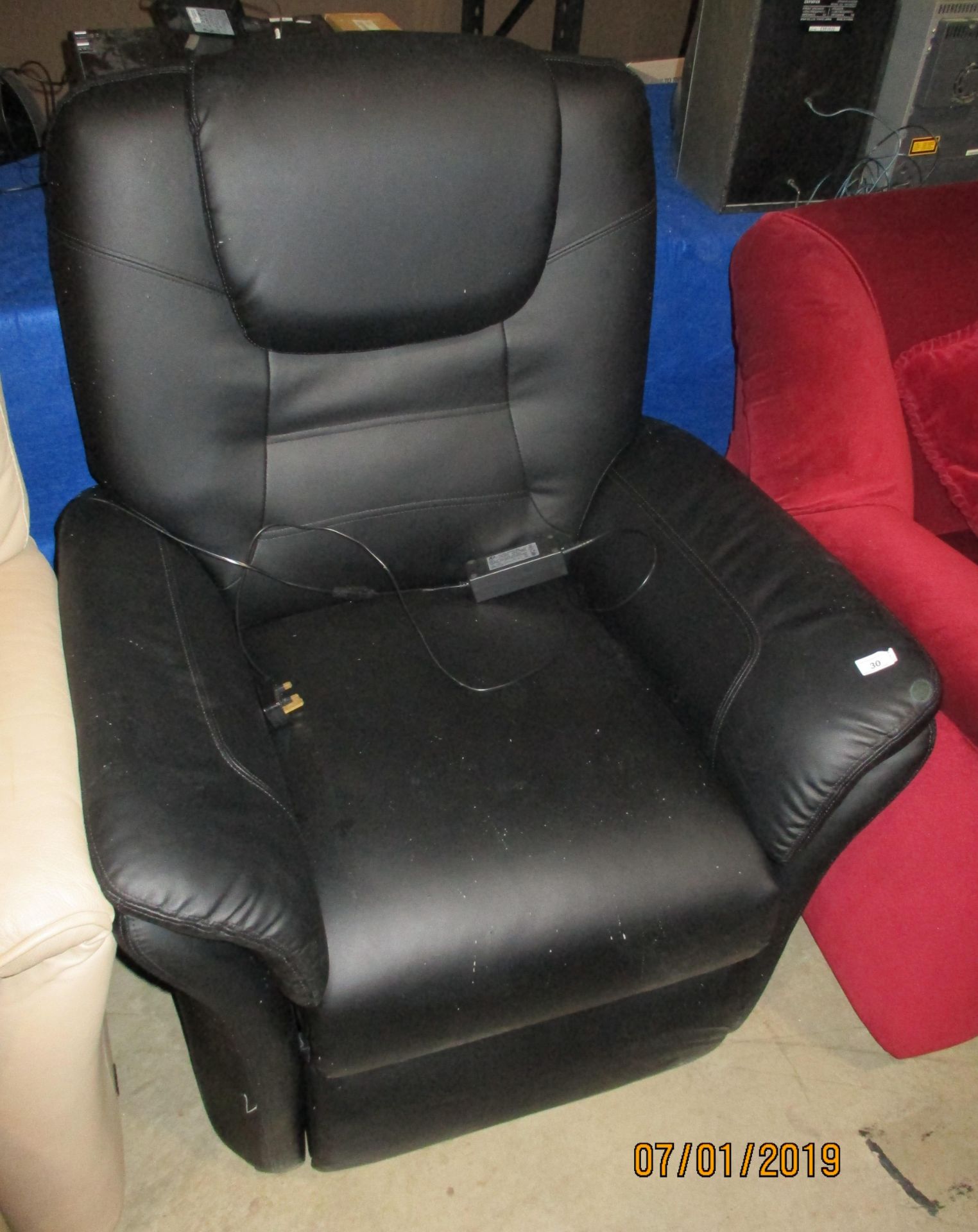 A black leather electric recliner armchair complete with power adaptor