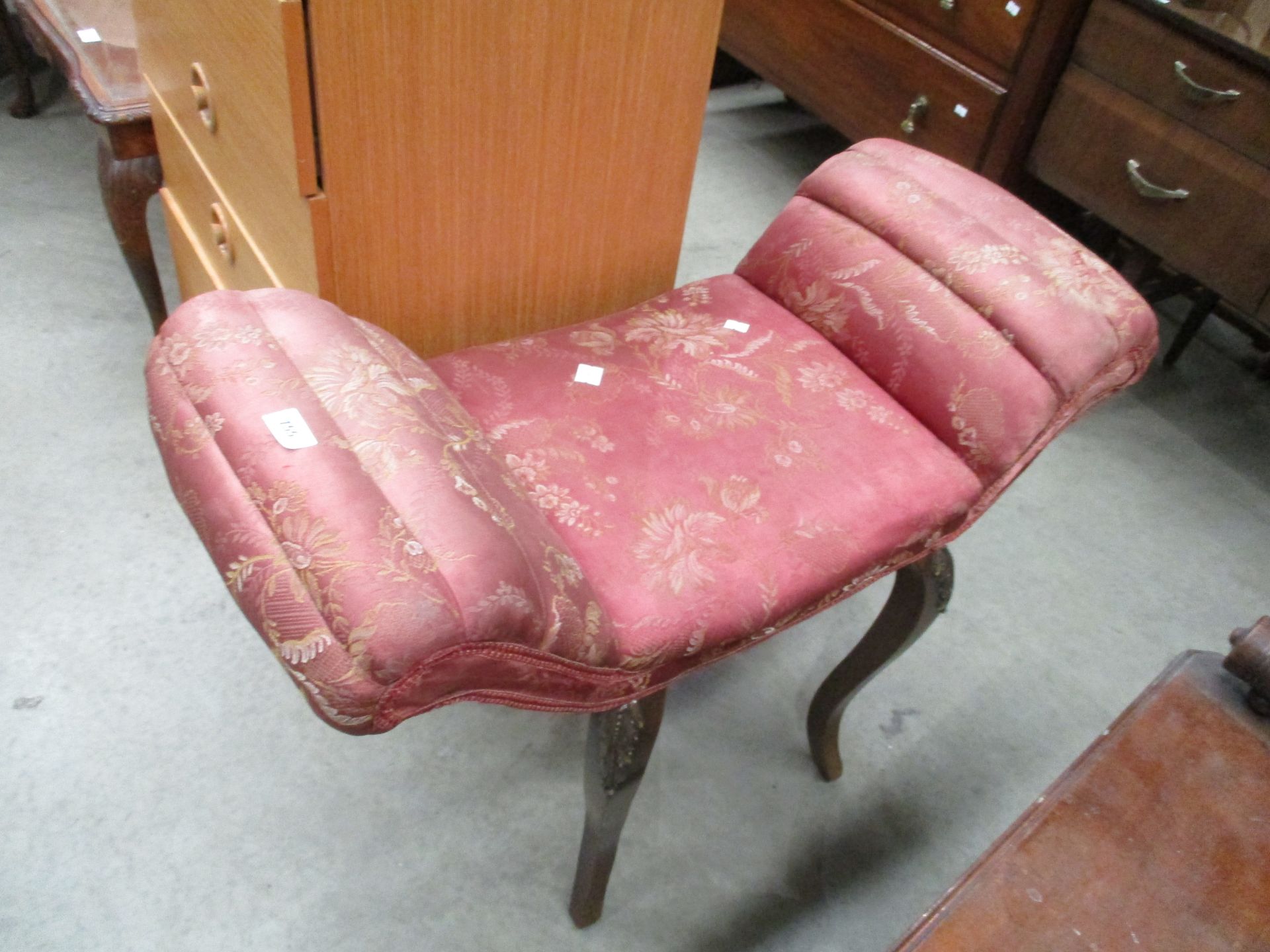 A pink patterned saddle stool