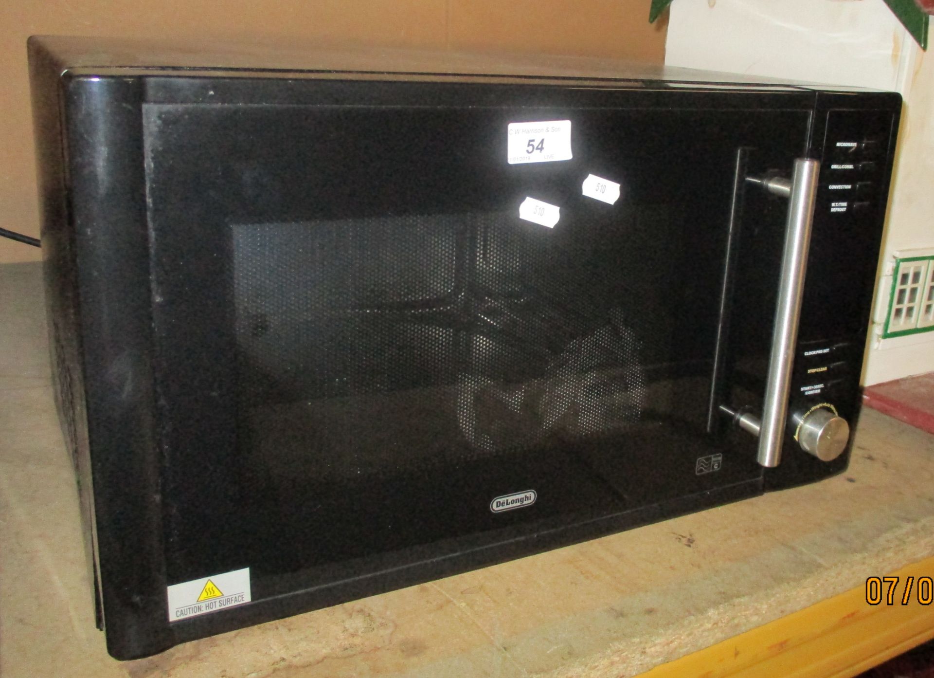 A black Delonghi microwave oven