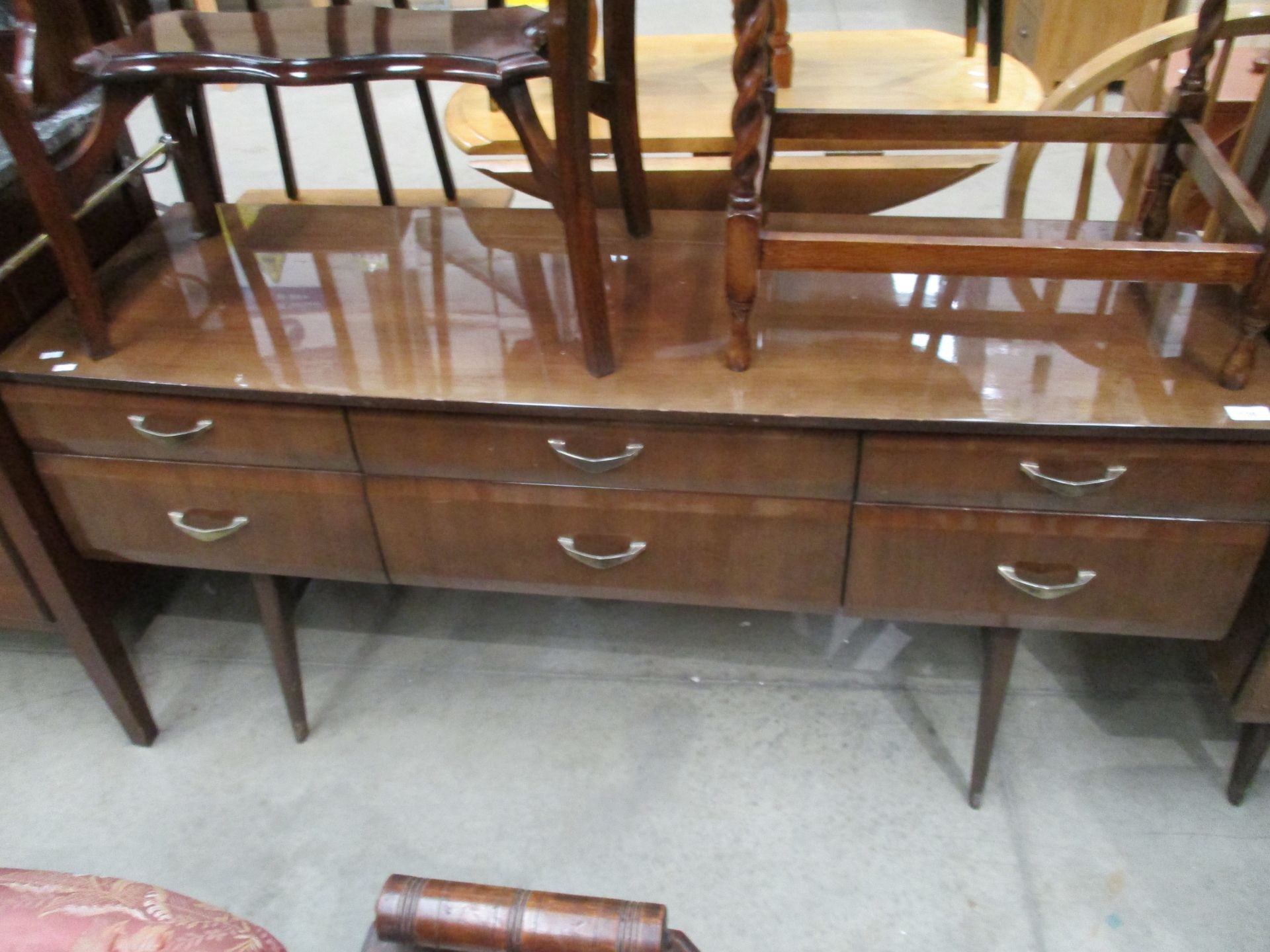 A Meredew 1950's walnut finish 6 drawer low side unit 140cm long with a matching 6 drawer chest of