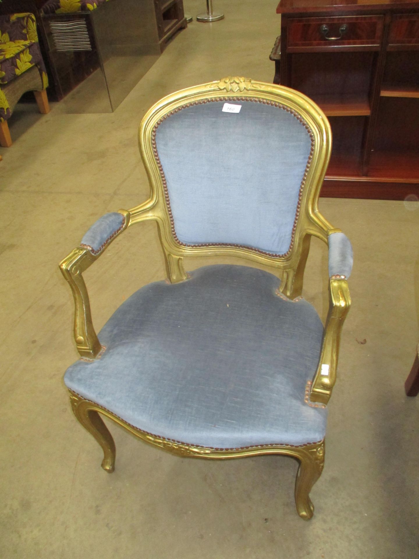 An Italian style gilt framed armchair with blue upholstery (Please note - the upholstery in this