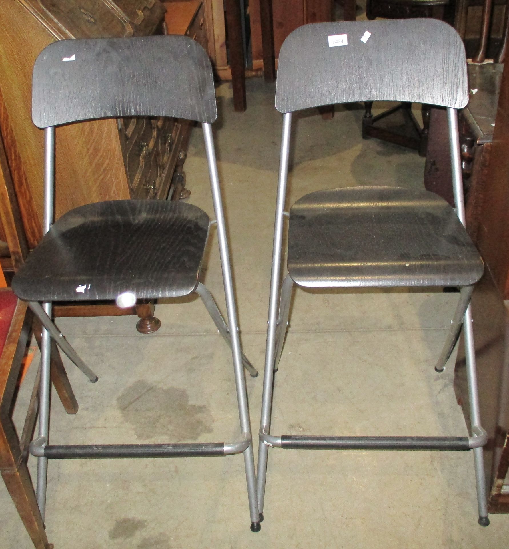 A pair of black ash effect folding kitchen chairs