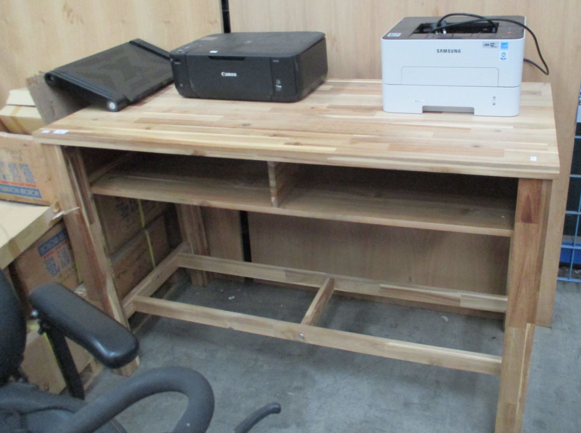 A parquet style light wood work bench with two open shelves under table top complete with 2