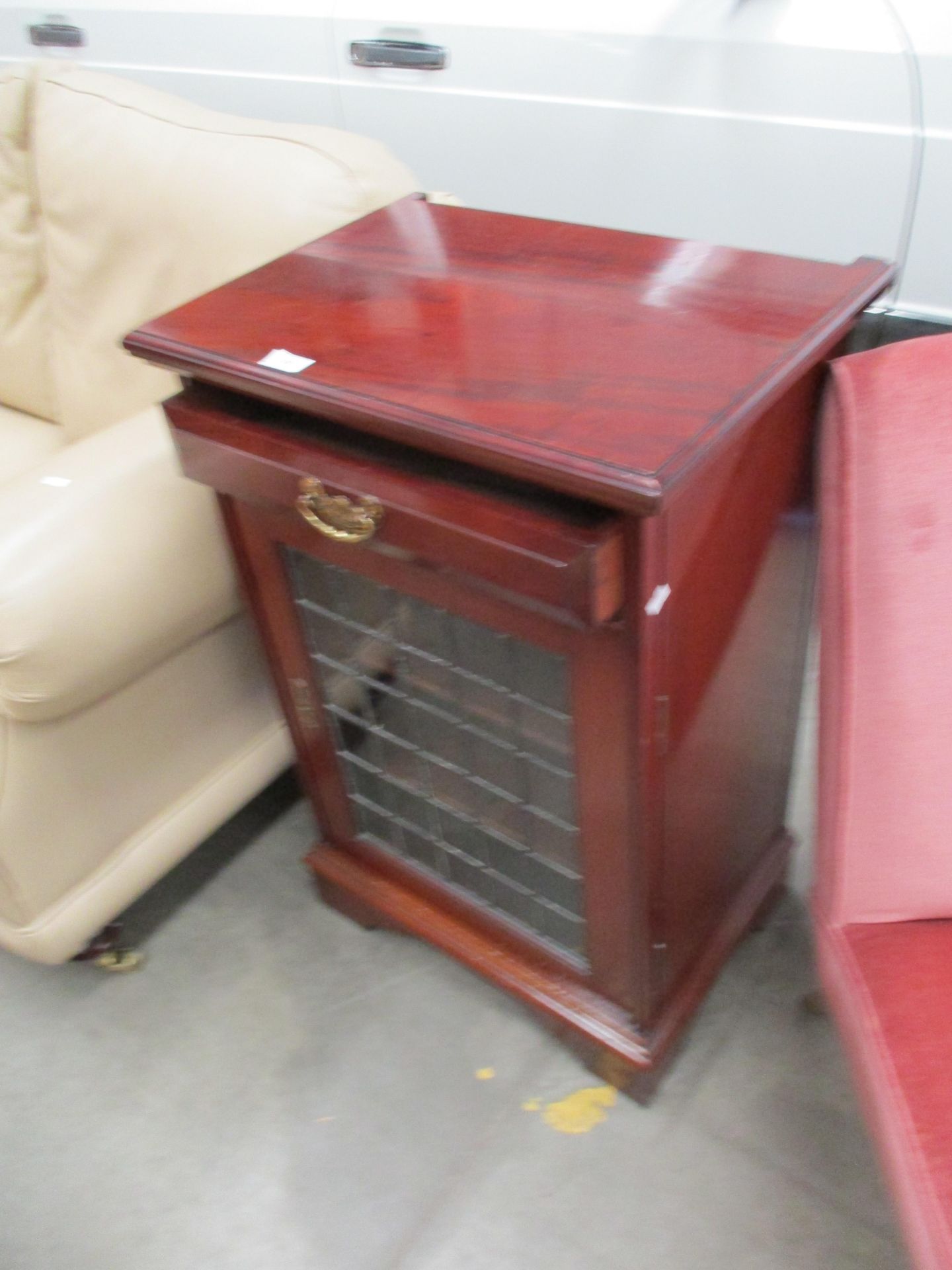 A mahogany single drawer single leaded glazed door side cabinet