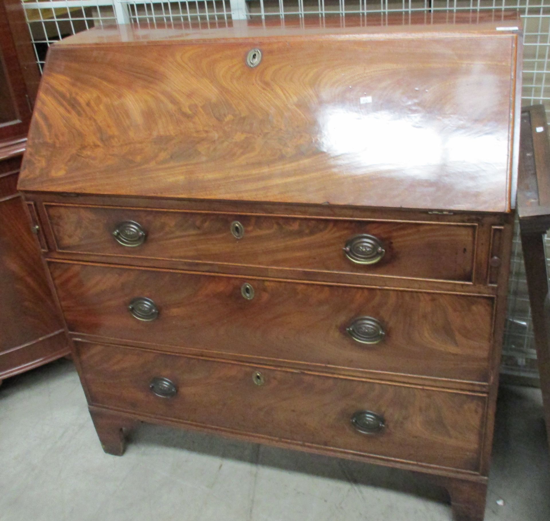 A George III figured mahogany fall front writing bureau,