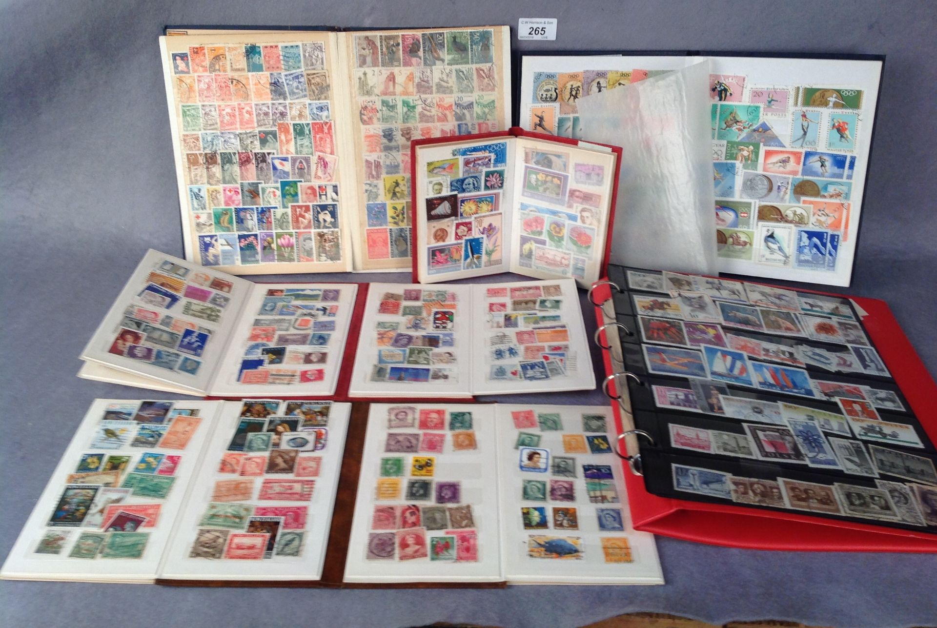 Four small stamp albums and one folder containing European and world stamps