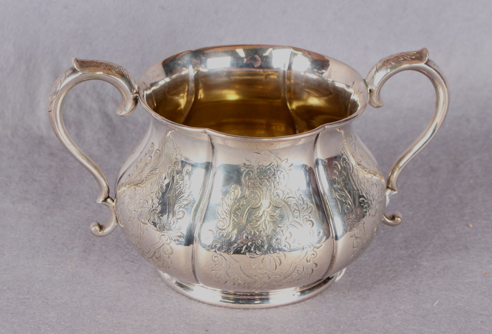 A Victorian two handled sugar basin of baluster shaped circular form, engraved with flowers,