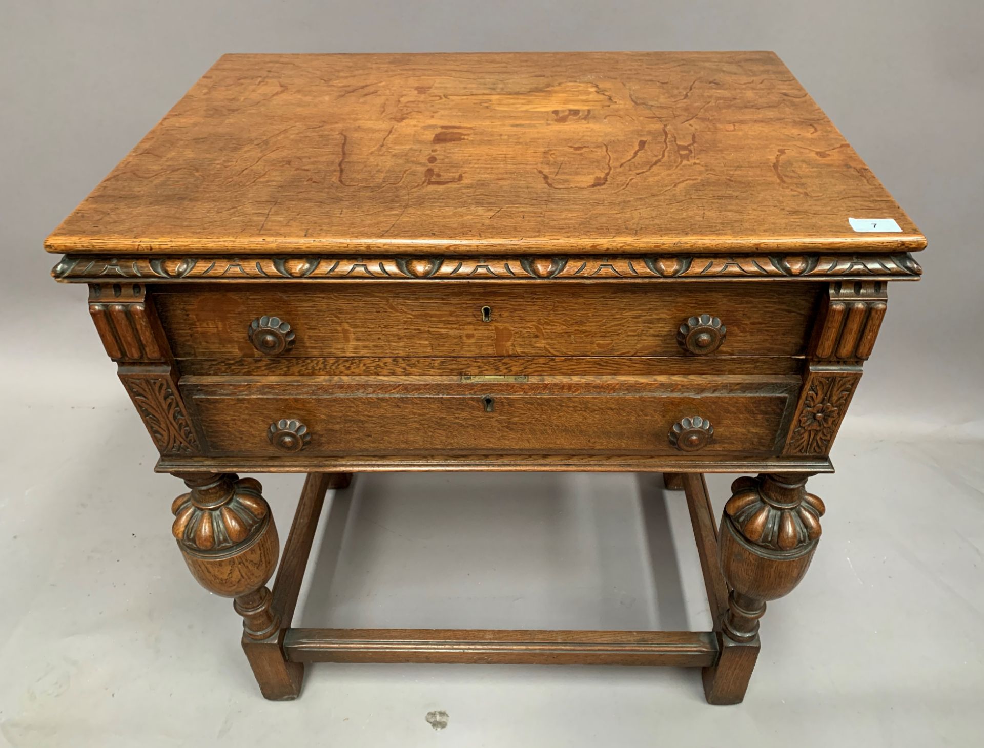 A part suite of table cutlery in an oak two drawer table canteen table,