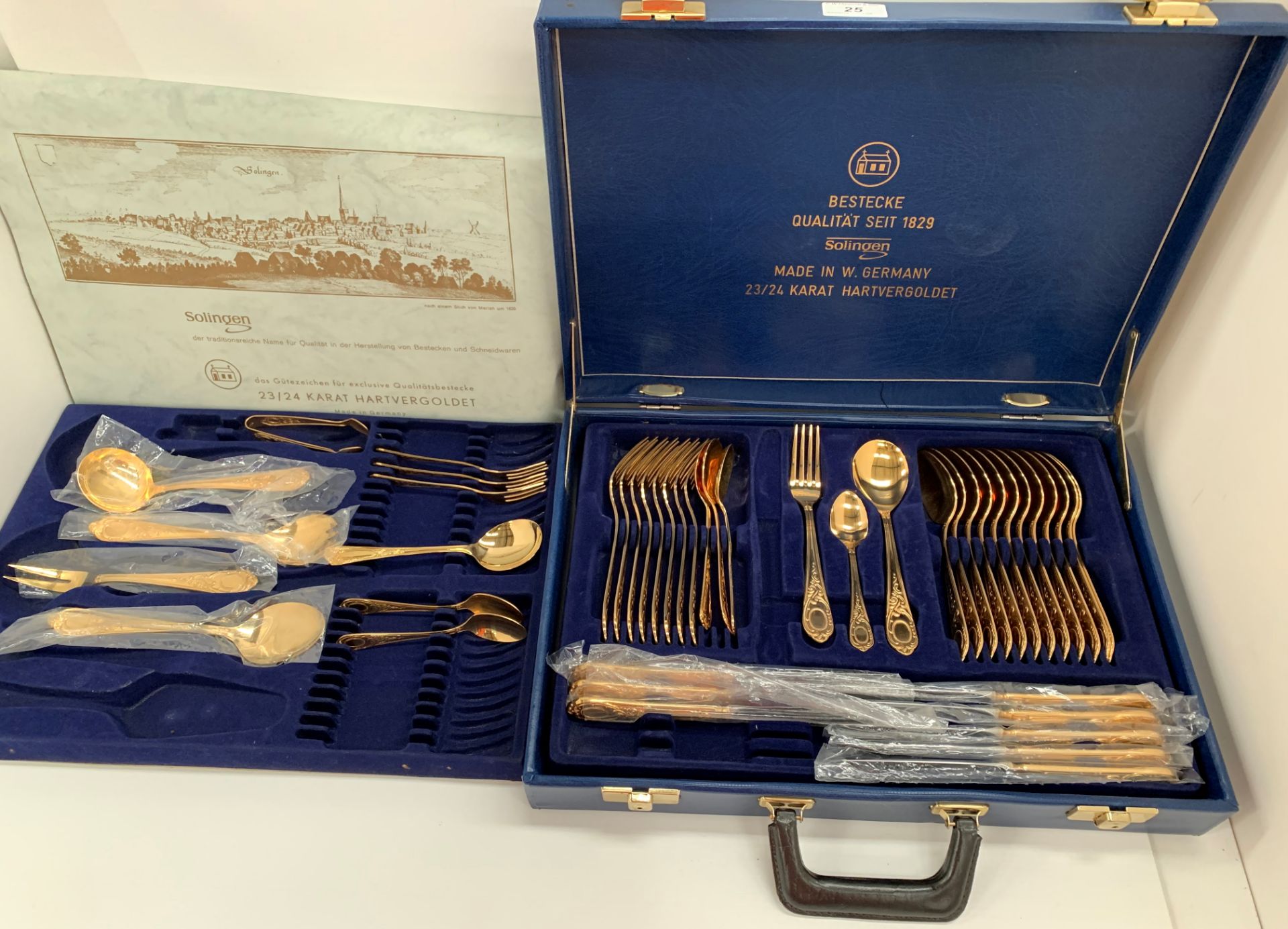 A Solingen 24 carat gold plated part canteen of table cutlery in a blue leatherette case