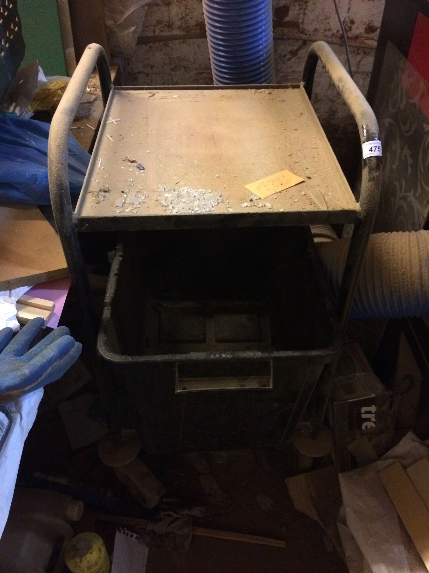 A metal worker's trolley in black with storage bucket