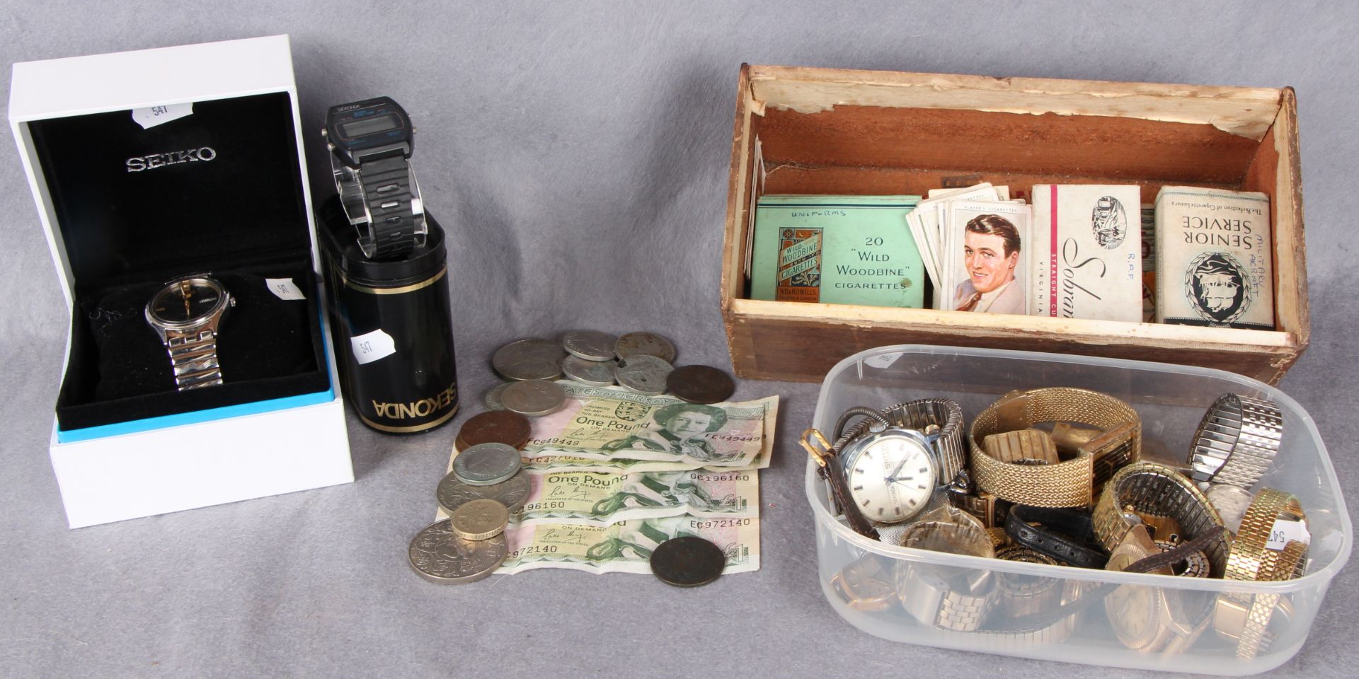 A collection of assorted ladies and gentlemen's fashion watches and a small quantity of cigarette