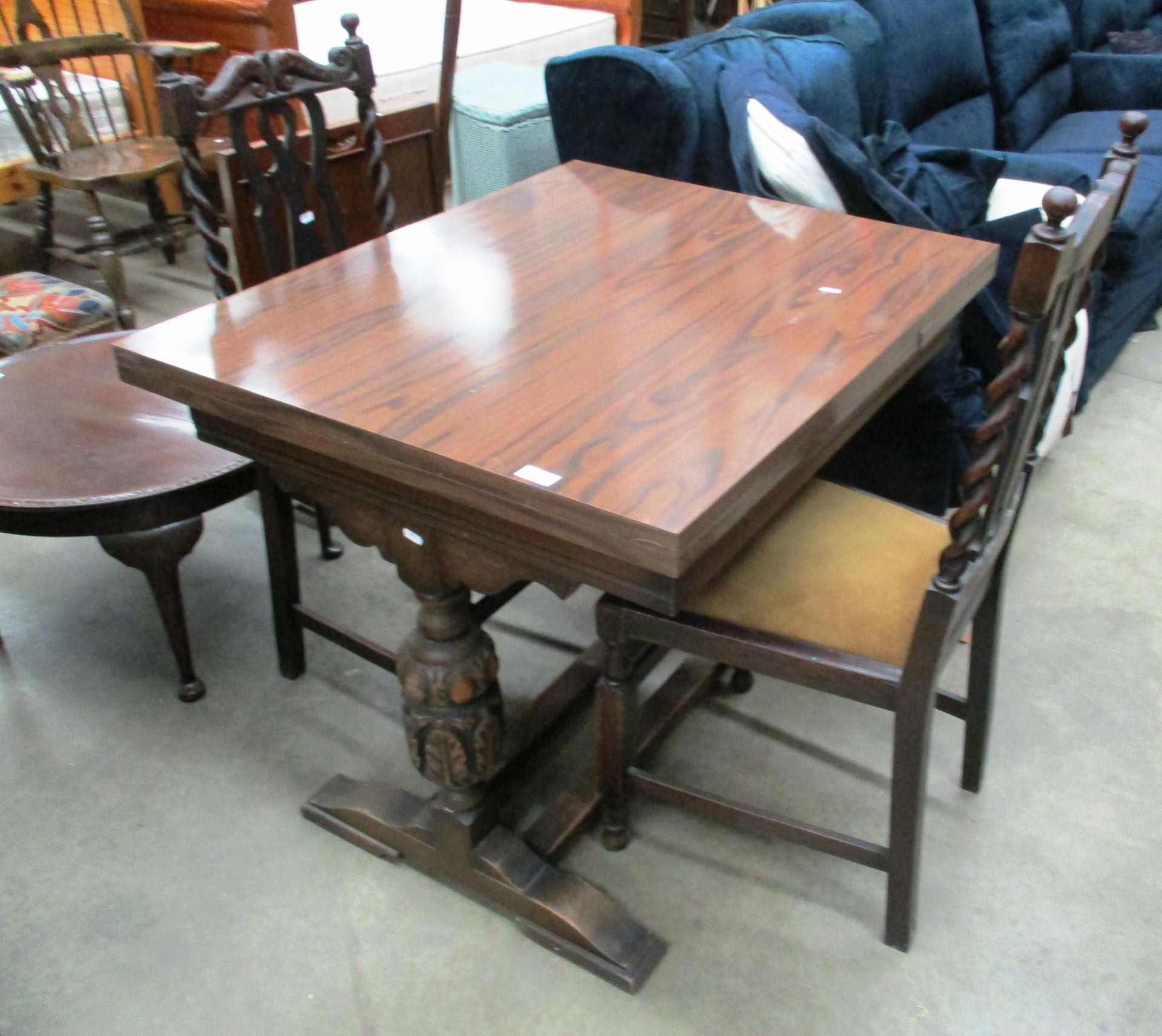 An oak slide leaf dining table on carved legs,