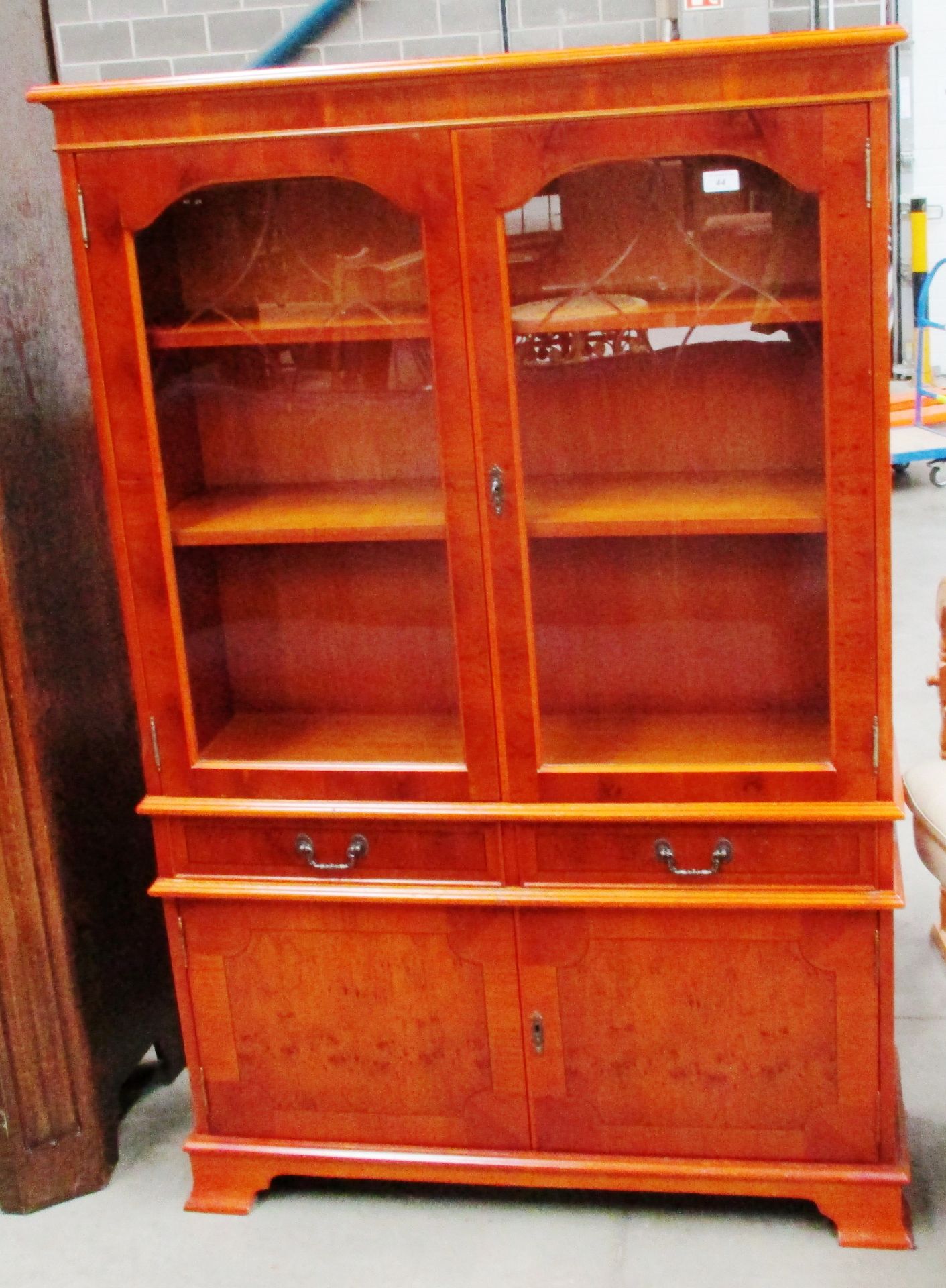 A Robert Mathew reproduction furniture yew wall unit with two glazed doors over 2 drawer 2 door