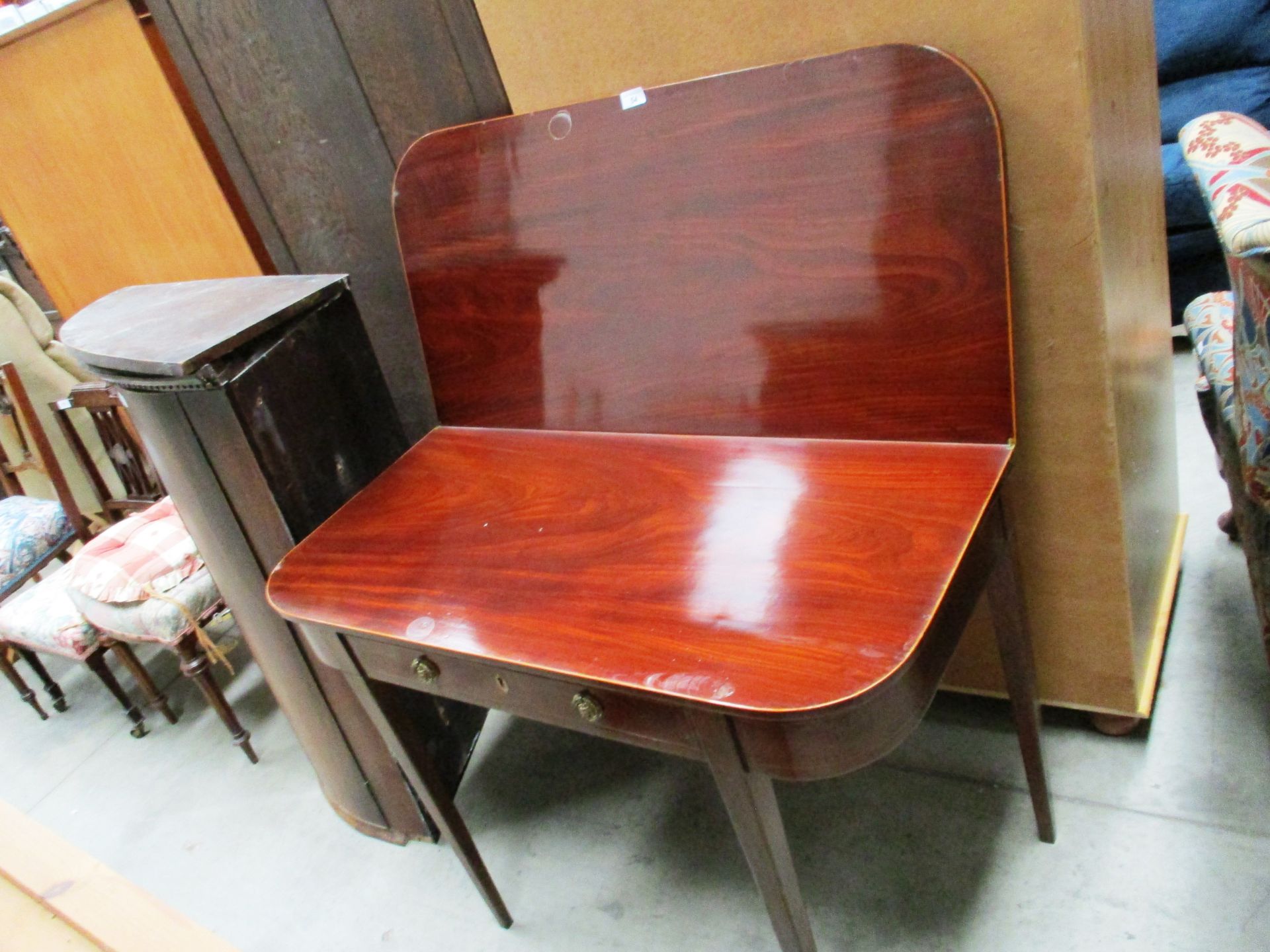 A 19th century inlaid mahogany folding top tea table with frieze drawer on square tapered legs 100