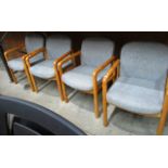 A set of four Gordon Russell oak framed boardroom armchairs with light grey cloth seats