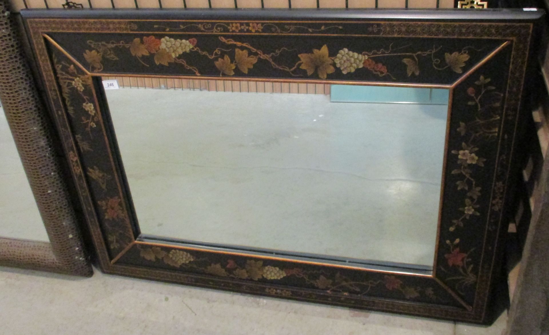An Oriental style framed wall mirror,