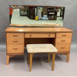 An Austinsuite teak seven drawer twin pedestal dressing table 134 cm wide,
