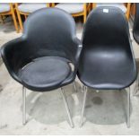 A black polypropylene shell chair on chrome legs and a black polypropylene tub armchair on chrome