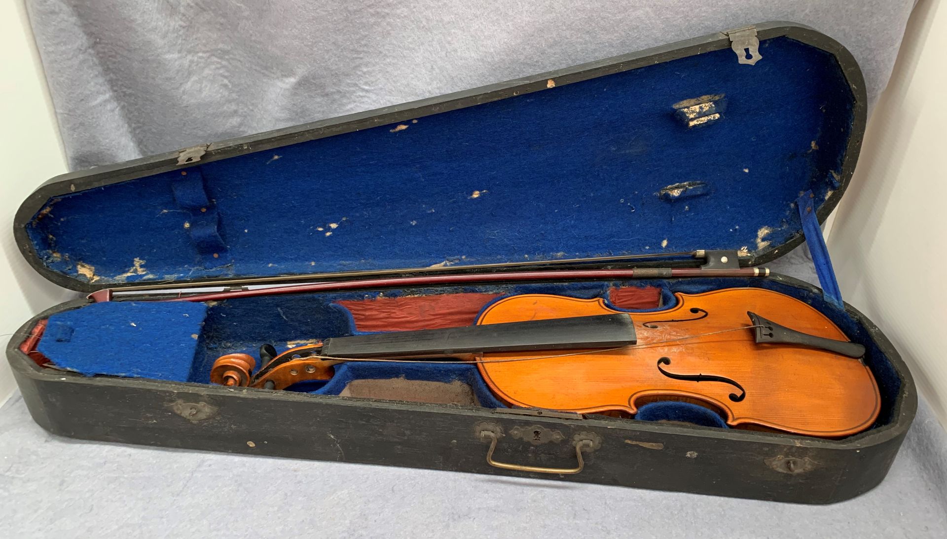 A violin in a stained pine case - 60cm long,