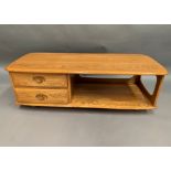 An Ercol blonde elm two drawer mobile low coffee table with under shelf 125 x 53cm