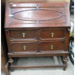 An oak bureau with fall flap over three drawer base 85cm