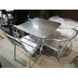 An aluminium framed outdoor cafe table MRP £130 and two non matching aluminium outdoor chairs MRP