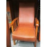 An oak framed reclining armchair with brown vinyl seat and back [Please note - the upholstery in