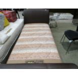 A brown leather finish framed 3' single bed with a Sundown Arrow Range Restus brown patterned