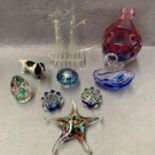 A collection of glassware including galleon, swan, mushroom, starfish, paperweights etc.