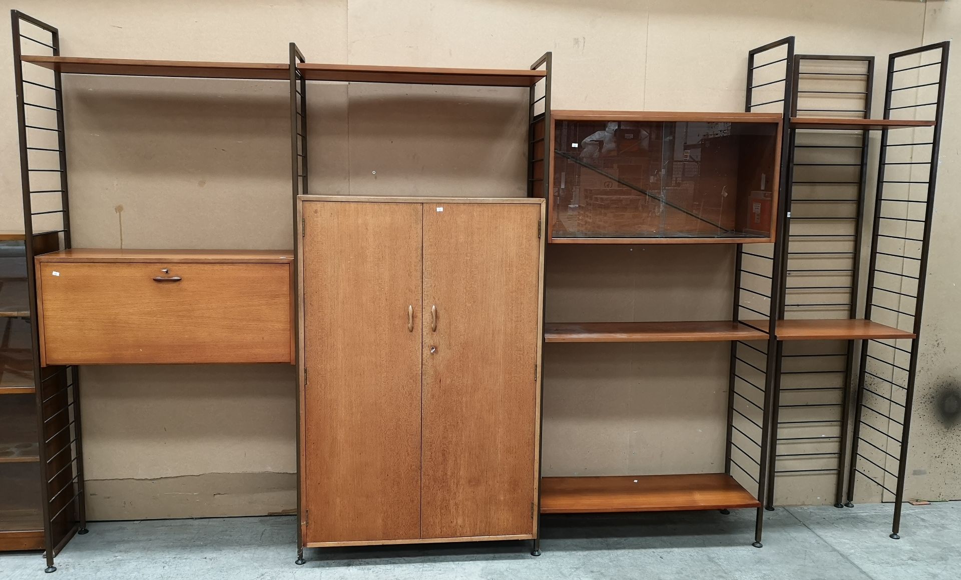 A teak and metal framed Staples Ladderax (with label) wall unit with cupboards,