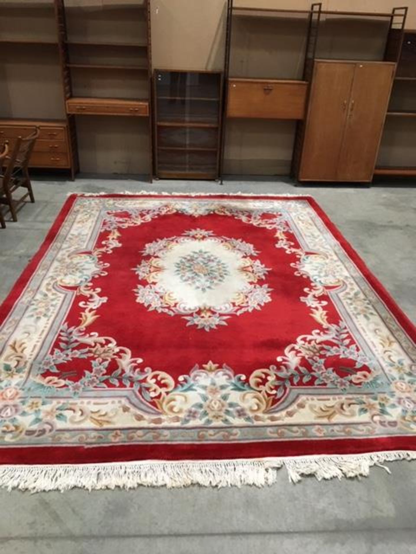 A red Chinese rug with beige/brown/blue border and centre medallion 360cm x 270cm