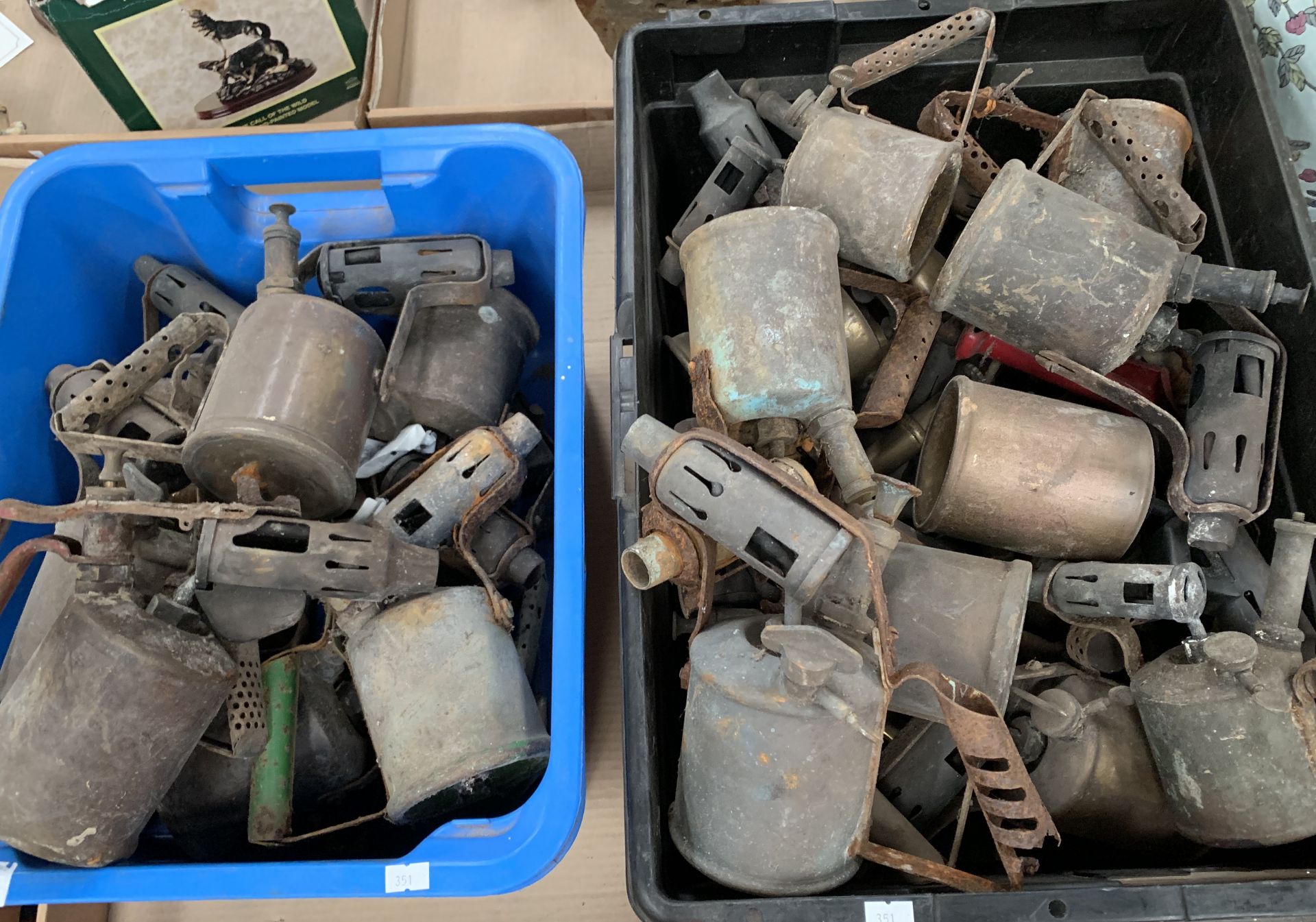 Contents to 2 plastic crates - a large collection of brass heat guns - many as viewed