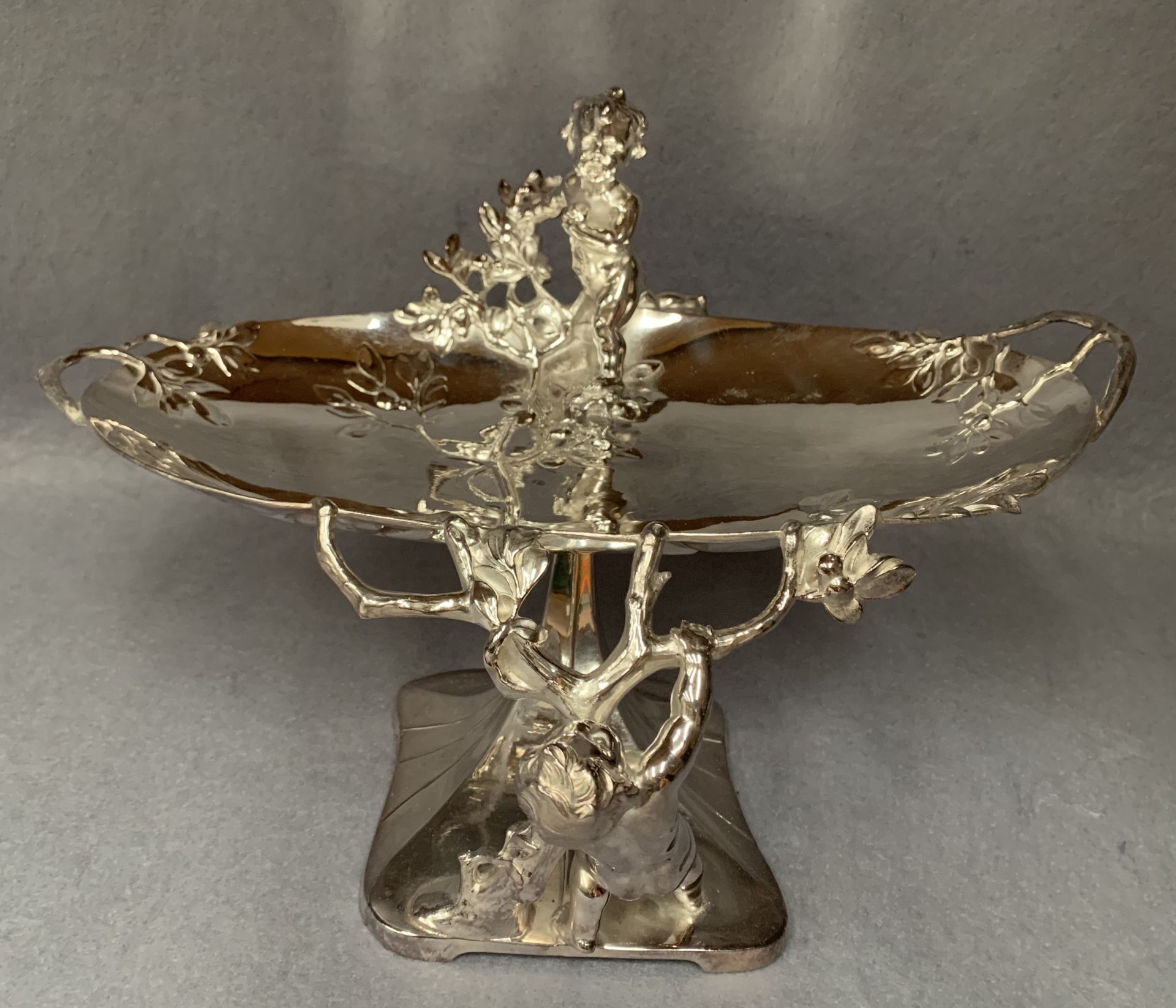A Continental plated prize centrepiece of oval organic form embellished with putti,