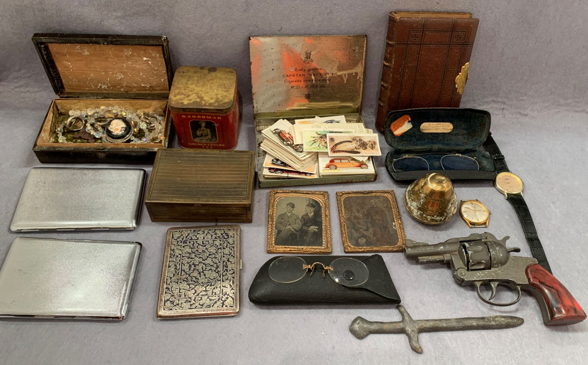 Contents to tray -toy gun, pince nez, engraved and other cigarette cases, costume jewellery,