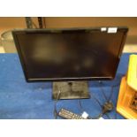 A Samsung T220390EW 22" flat screen TV with remote control and adapter