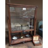 A Griffin and Tatlock Ltd brass chemist scales in an oak glazed front case,